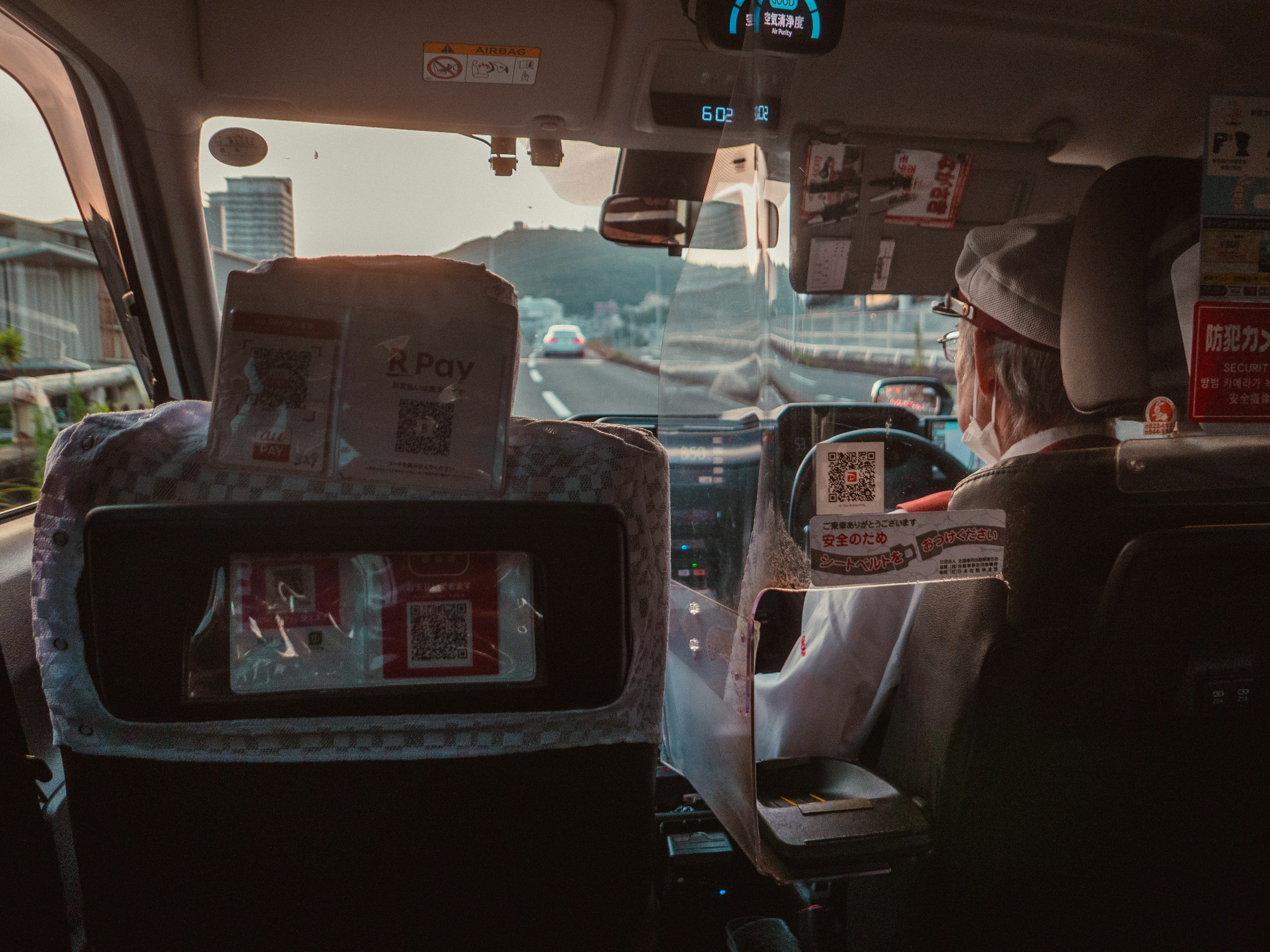 A taxi driver seen from the back seat