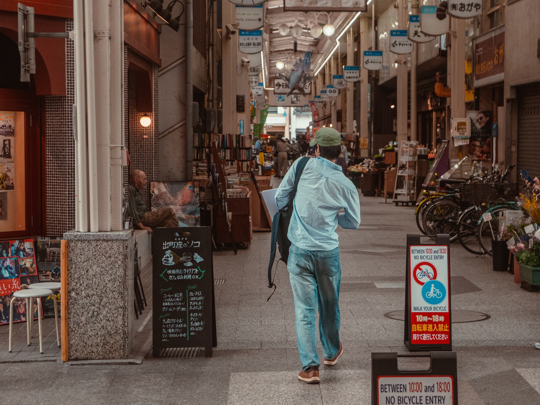 A man walking through a covered shopping arcade
