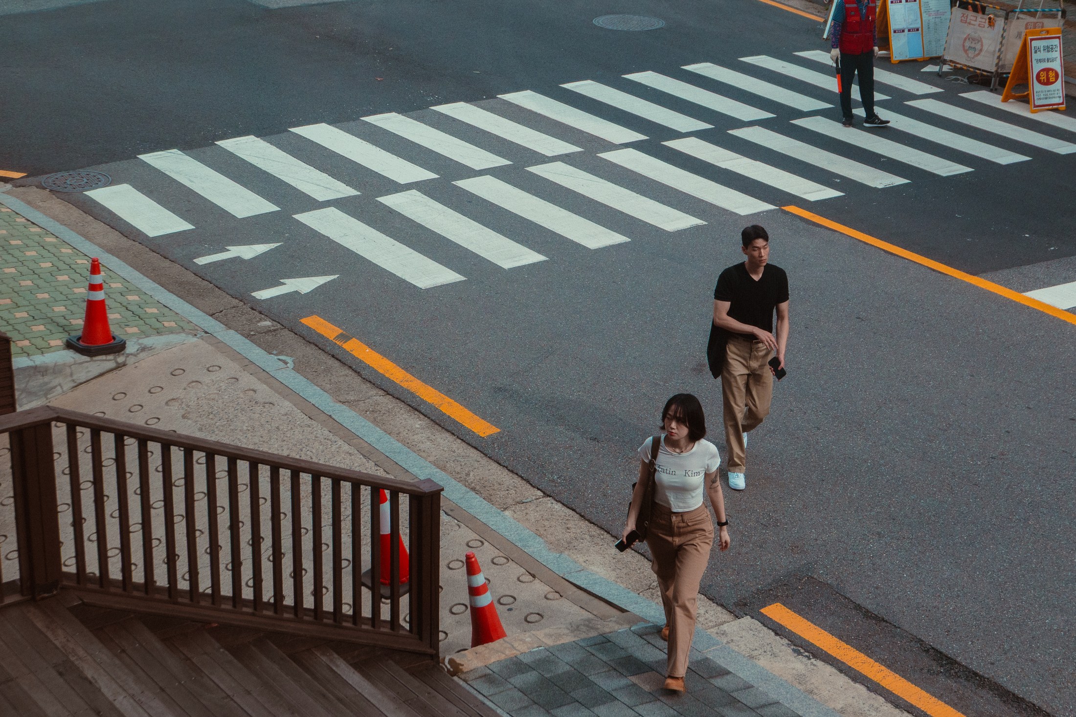Two pedestrians crossing a graphic city intersection
