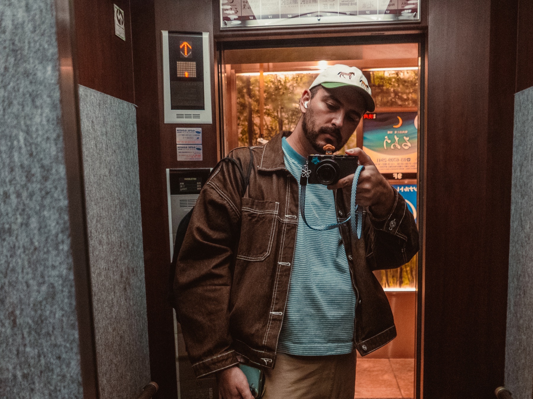 Ryan taking a mirror selfie in an elevator